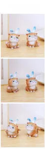 Detailed close-up of creative cat figurines with rabbit ears and glasses on wooden desk