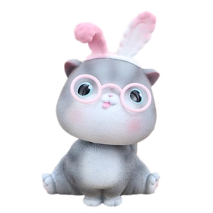 Cute gray cat desktop ornament with pink glasses and bunny ears on white background