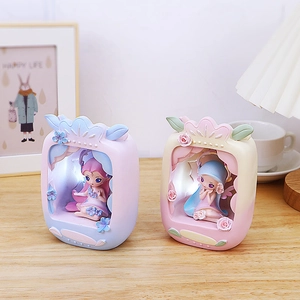 Close-up of LED fairy night lights in retro TV shape on a cozy wooden bedside table