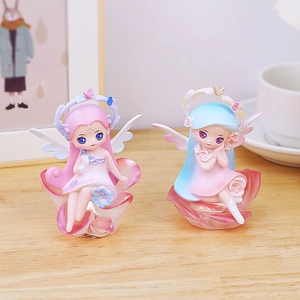 Detail of fairy night light resin figurines with floral wings on petal bases