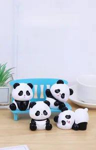 Detailed view of four cute panda figurines with a miniature blue bench on a wooden desk