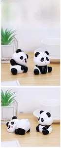 Close-up of cute panda figurines in various poses on a wooden table with home decor