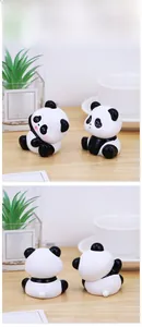 Close-up of cute panda miniature resin figurines showing front and back design details