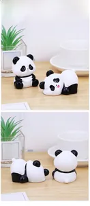 Detailed close-up of cute panda desk ornaments in sitting and lying poses on wood