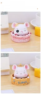 Close-up of cute cartoon mouse ornaments on pink cream and yellow cheese bases
