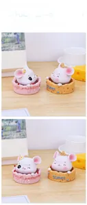 Detail of cute mouse resin figurines with Sweet base on a wooden desk with cozy decor