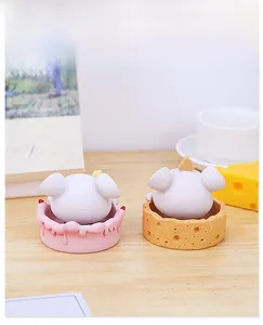 Rear view of cute cartoon mouse figurines on cake and cheese bases for desk decor
