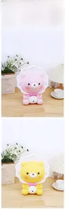 Close-up of pink and yellow cartoon bear night lights on a cozy wooden table set
