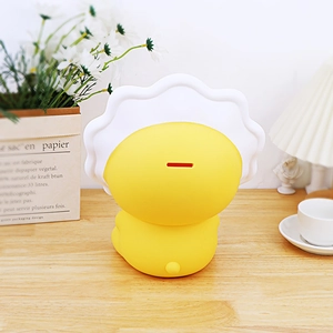 Rear view of yellow cartoon bear piggy bank with white wave pattern on a cozy desk