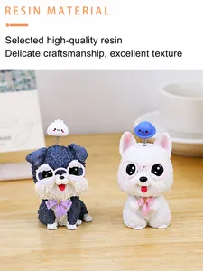 Detail of cute resin dog figurines with spring-head accessories on wooden desk