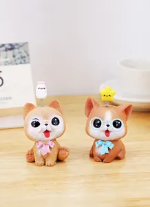 Close-up of cute resin puppy ornaments with glasses on a wooden desk scene