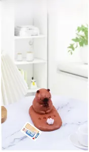 Close-up of Zen Capybara desk ornament with lotus flower and Emotional Stability text