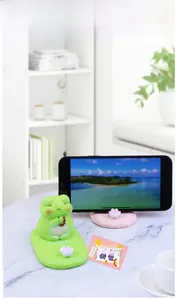 Cute green frog phone stand on a pink lotus base with good luck message decor