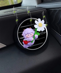 Detail of cute purple sheep cartoon car air vent clip with a daisy flower and leaf accent