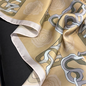 Close-up of geometric chain and rose print on elegant champagne silk satin square scarf
