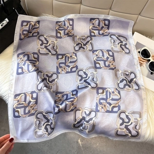 Detailed close-up of a vintage floral silk scarf featuring elegant chain print patterns