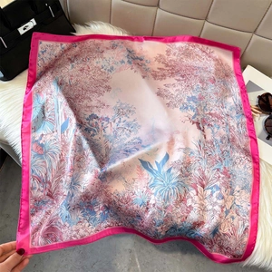 Artistic rainforest floral silk scarf with pink borders on a plush white texture