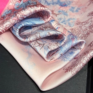 Detail of artistic floral print silk scarf with satin luster and elegant draping effect