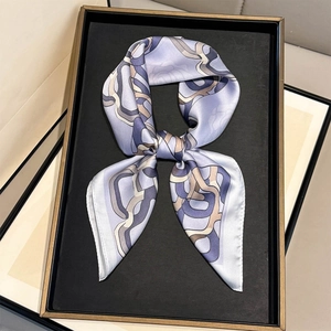 Elegant light purple silk scarf with geometric chain print displayed on a black tray
