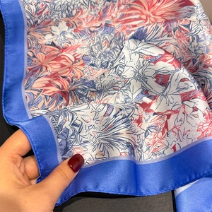 Close-up of French rainforest floral silk scarf showing smooth texture and contrast border