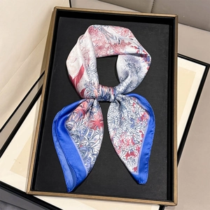 French rainforest floral print silk square scarf with blue border on display tray