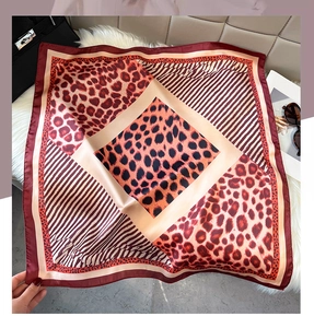 Close-up of leopard print satin square scarf showing smooth texture and vintage pattern