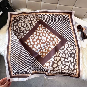 Silk leopard print square scarf for women styled with luxury bag and sunglasses