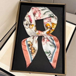 Elegant floral silk scarf for women featuring pink and yellow blossoms in a gift tray