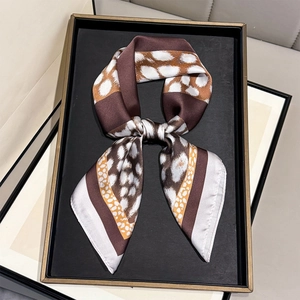 Detail of faux silk leopard print scarf with smooth texture and hemmed edges