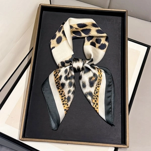 Elegant 70cm leopard print faux silk square scarf tied in a bow on a luxury tray