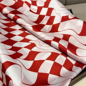 Macro shot of red and white checkered silk fabric with elegant wavy geometric texture