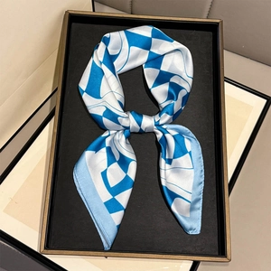 Close-up of blue and white geometric checkered silk scarf with satin texture finish