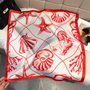 Elegant silk scarf with red sea shell and starfish print styled with luxury accessories