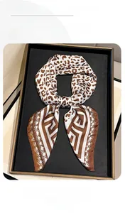 Detailed view of leopard print and Greek key pattern on soft silk fashion scarf