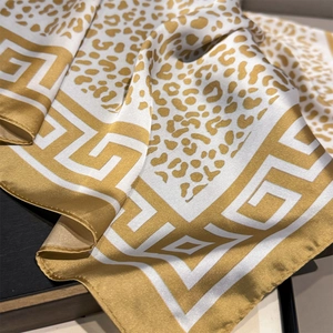 Luxurious leopard and Greek key print silk scarf with golden satin finish and elegant drape