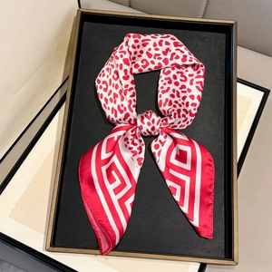 Fashionable leopard and geometric pattern silk scarf displayed on a luxury black tray