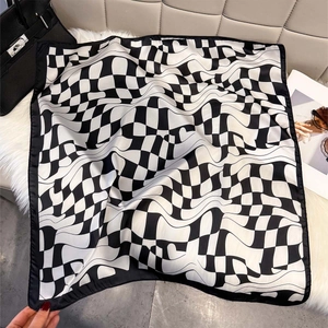 Luxurious geometric square silk scarf with black and white distorted checkerboard pattern