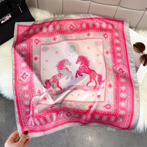 Detail of luxury silk square scarf with horse print and elegant pink and grey pattern