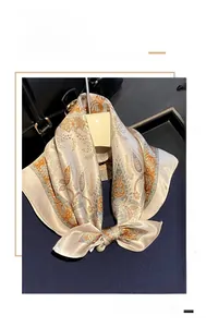 Detailed texture of 100% mulberry silk square scarf with elegant paisley floral patterns