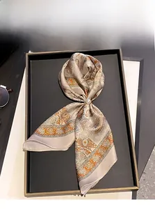 Detail of 100% mulberry silk scarf with paisley pattern and elegant pearl buckle closure