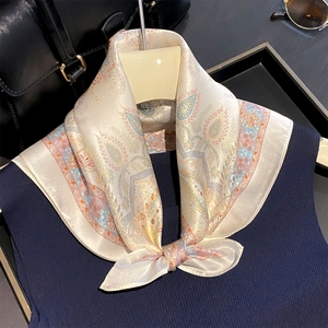 Detailed view of paisley print on luxury 100% mulberry silk neckerchief for women