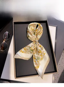 Detail of 100% mulberry silk scarf with leaf prints and a pearl metal ring buckle