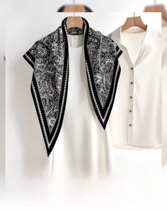 Detail of vintage paisley triangular scarf paired with white clothing for versatile styling