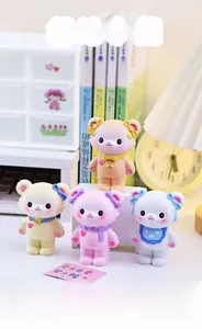 Detailed view of four colorful resin cream bear figurines set on a cozy desk setup