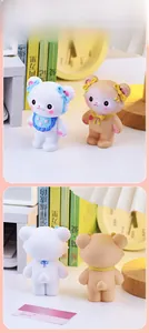 Front and back detail of cute resin bear figurines with blue and yellow bow ties