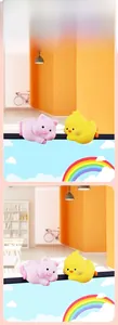 Close-up of mini pig and duck silicone animal decor hanging on monitor edge