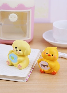 Cute resin puppy and duck figurines holding signs on a desk for office decoration