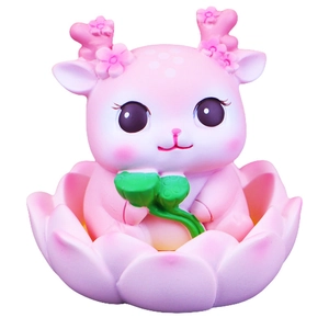 Pink deer figurine sitting in a lotus flower base for desktop and car decoration