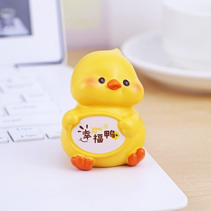Cute yellow duck desk ornament holding a Lucky Duck sign for office decor and gifts