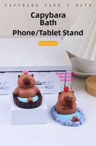 Close-up of Capybara desk phone stands in rock pool and wooden tub bath designs